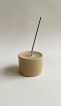 Minimalist stoneware incense holder, 3/4 angle as default to showcase both form and surface detail; objects placed with...